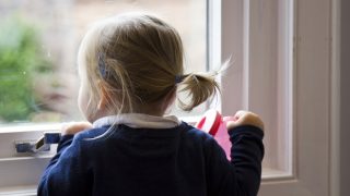 Young girl looking out window at YourGP children's clinic