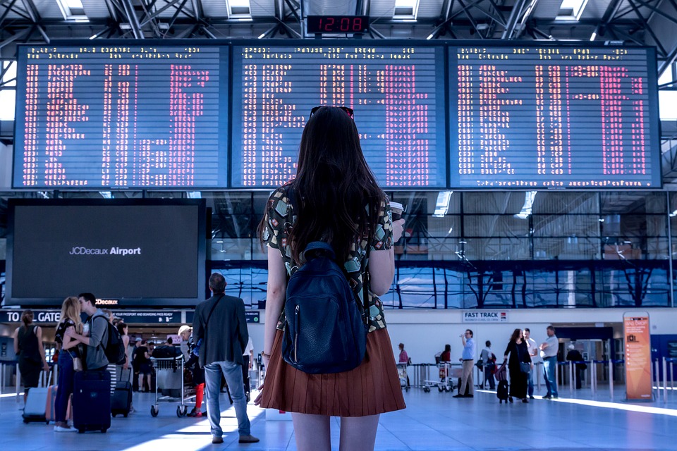 Person at the airport, ready for travel after visiting a travel health clinic and receiving travel vaccinations.